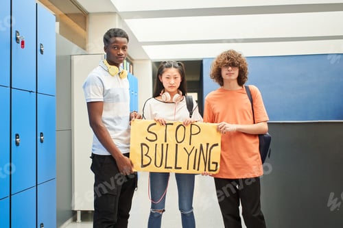 Preview: A group of students display a banner with the phrase: Stop Bullying.