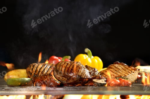 Preview: Grilled meat /steak with vegetable on the flaming grill