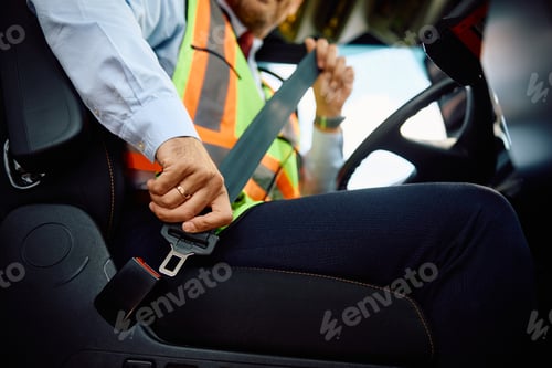 Preview: Close up of bus driver fastening seatbelt.