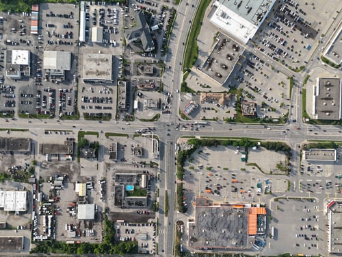 Preview: Aerial view of a commercial and industrial area with various buildings, parking lots, and roads