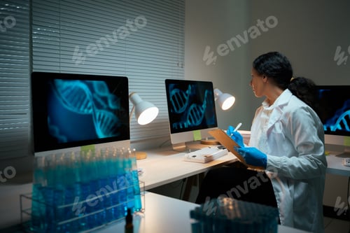 Preview: Scientist analyzing DNA structures on computer screens in lab