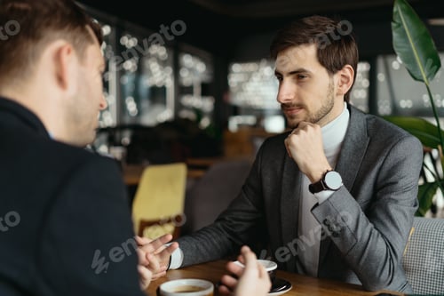 Preview: Two young businessmen discussing something