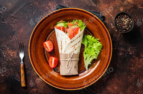 Preview: Wrap roll sandwich with fish salmon and vegetables. Dark background. Top view