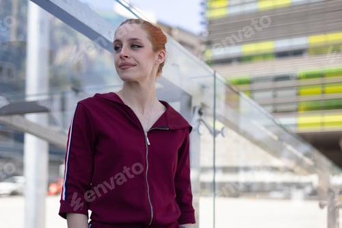 Preview: Young woman with red hair in urban environment