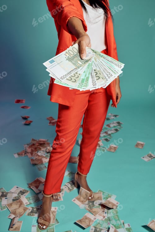 Preview: Closeup of hands holding, showing and displaying money while standing against a blue studio backgro