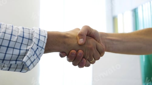 Preview: Close up of handshake on white background, agreement and making a deal concept. Stock footage. Two