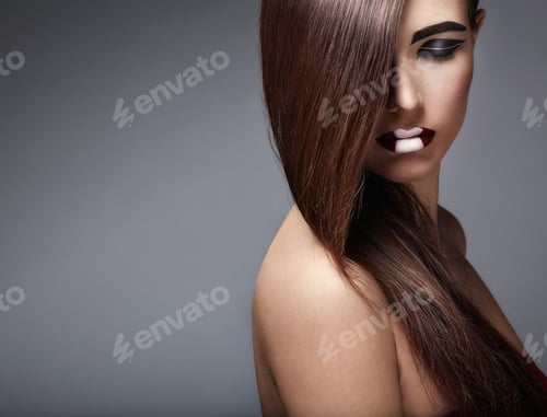 Stylish Woman with Bold Makeup in Studio