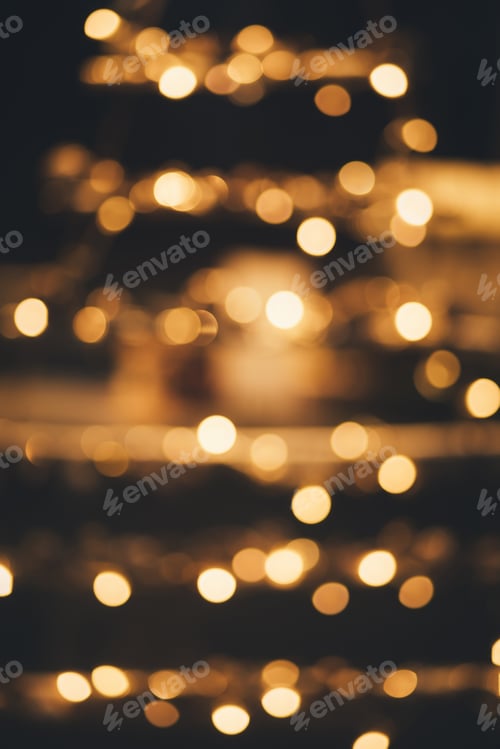 Preview: Blurred golden lights on a black background.