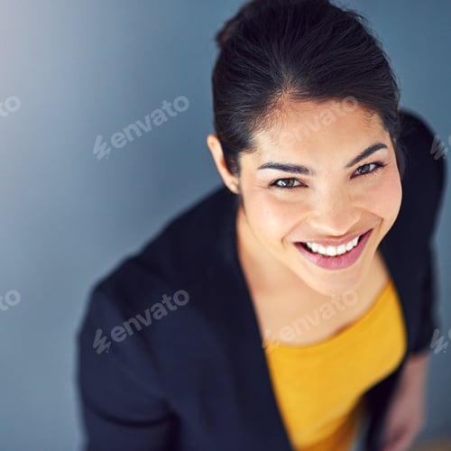 Preview: Studio portrait of an attractive young businesswoman standing against a blue background
