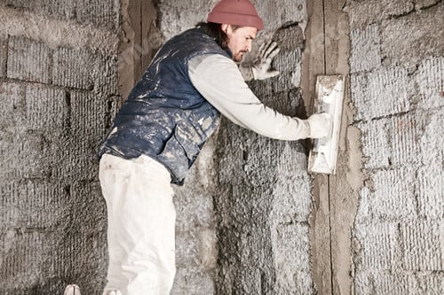 Preview: Real Construction Worker Working On A Wall Inside The New House.