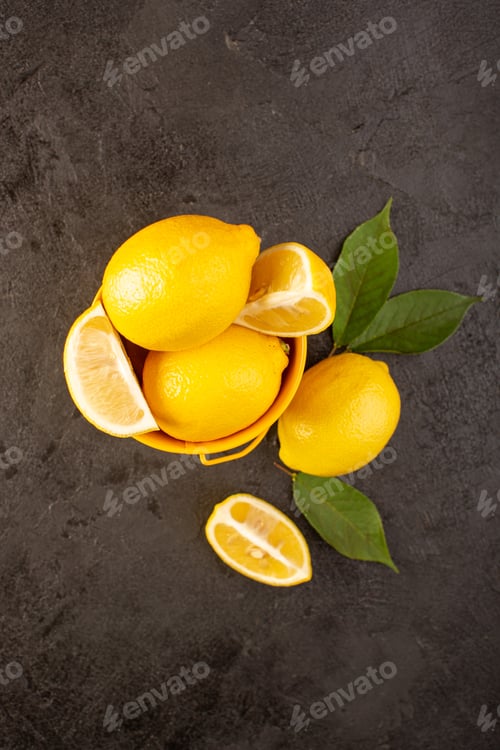 Preview: a top view yellow fresh lemons mellow and juicy whole and sliced inside yellow basket spread with