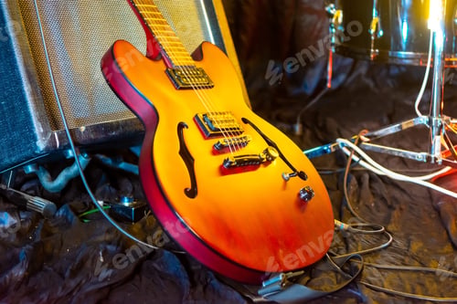 Preview: musician's guitar at a rock band concert indoors