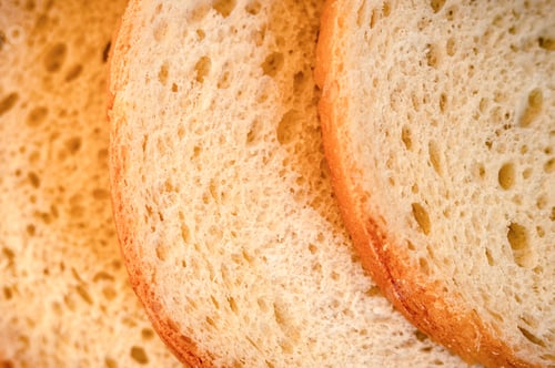 Preview: texture of chopped slices or pieces white bread loaf as background natural organic food with holes