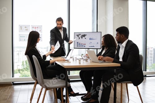 Preview: Business meeting with team discussing charts and documents