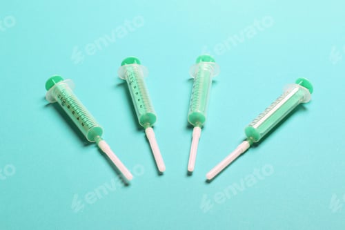 Preview: Top view of medical syringes on colorful background. Health care concept with copy space