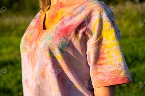 Preview: Cropped image of woman in t-shirt covered colourful holi powder paint.