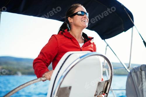 Preview: Attractive strong woman sailing with her boat