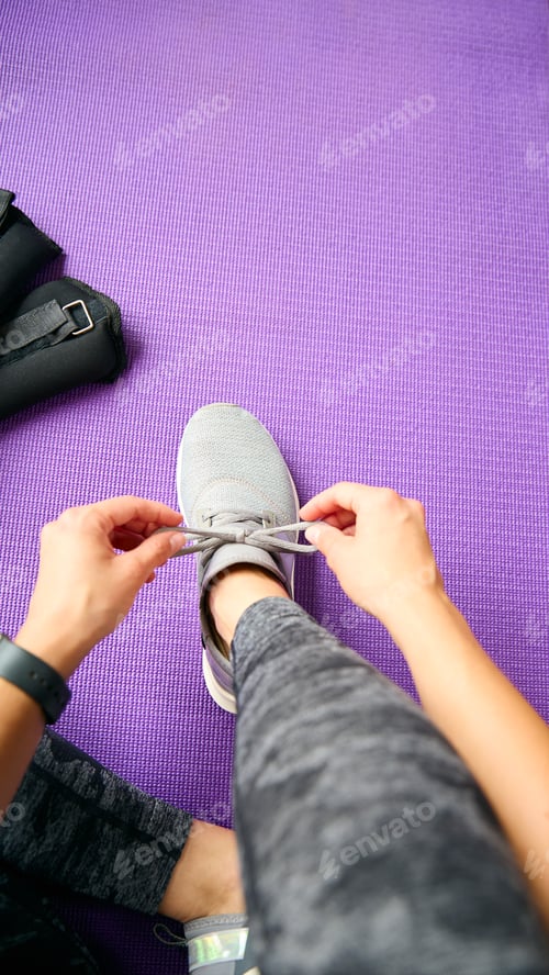 Preview: Close Up Looking Down On Woman About To Exercise Tying Shoelaces