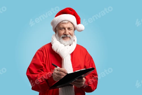 Preview: Happy mature Santa Claus holding pen and black clipboard