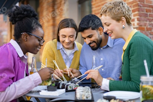 Preview: Friends Sharing Sushi Outdoors