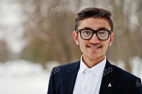Preview: Close up portrait of stylish indian student man in suit and glasses posed at winter day outdoor.