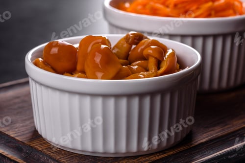 Preview: Homemade pickled honey agarics mushrooms in a white bowl
