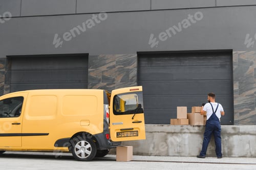 Preview: Courier loading cardboard boxes into a delivery van