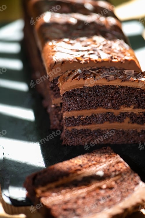 Preview: Chocolate cake on a black stone with delicious cacao cream