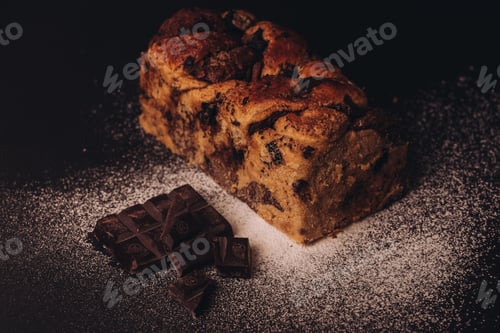 Preview: a loaf of bread next to pieces of chocolate on a plate