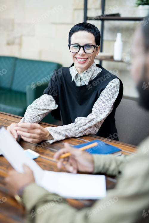 Preview: Cheerful business lady at meeting