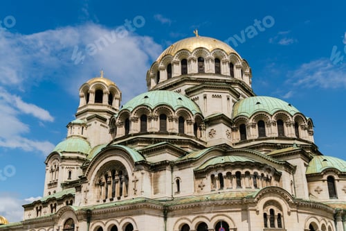 Preview: Majestic cathedral under a blue sky with fluffy clouds