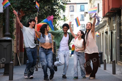 Preview: Young activists celebrating gay pride holding rainbow flags and marching down the street