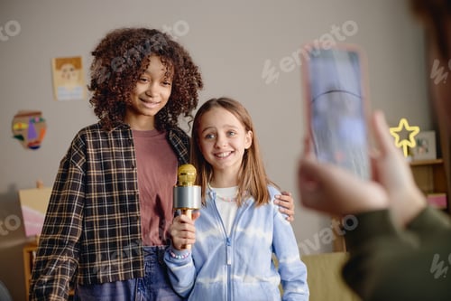 Preview: Portrait of Multiethnic Generation Alpha Girls Smiling While Holding Microphone
