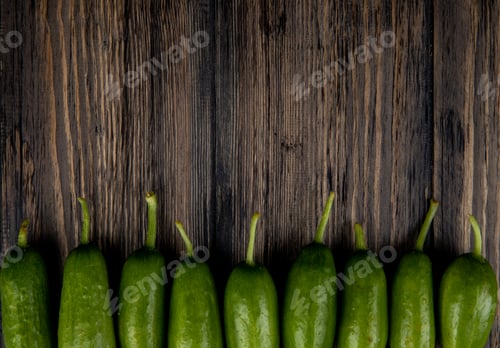 Preview: horizontal view of cucumbers on wooden background with copy space