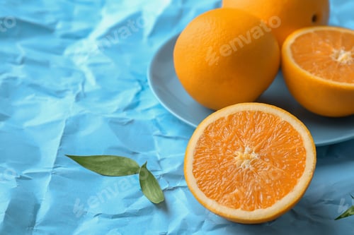 Preview: Fresh yummy oranges on color paper background