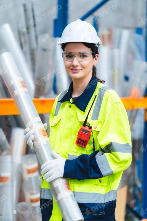 Preview: Portrait female professional engineer factory in protective uniform operating machine