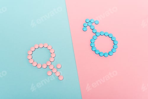 Preview: High angle view of female and male signs from hormonal pills on blue and pink background