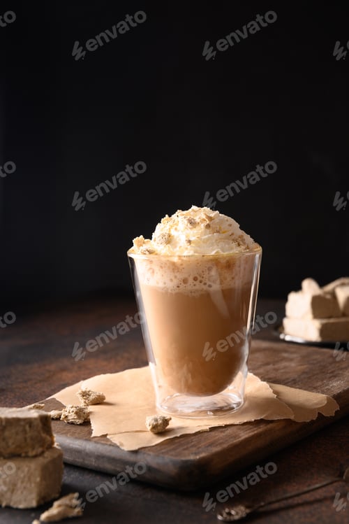 Preview: Tasty coffee latte with halva in glass cup.