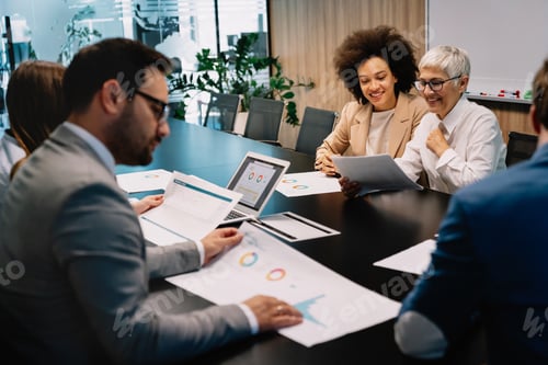 Preview: Business colleagues in conference meeting room during presentation