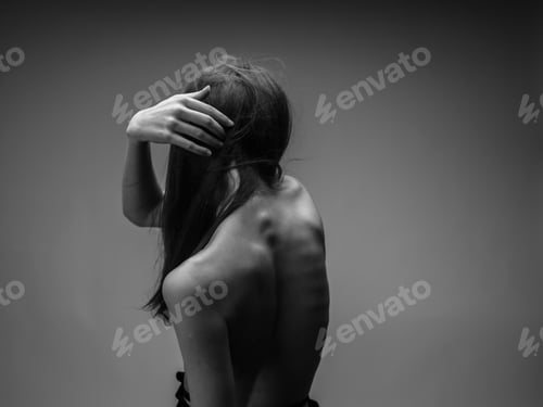 Preview: Black and white photo of a long hair model touching herself with hands