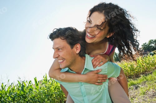 Preview: Germany, Bavaria, Man carrying woman on back, smiling