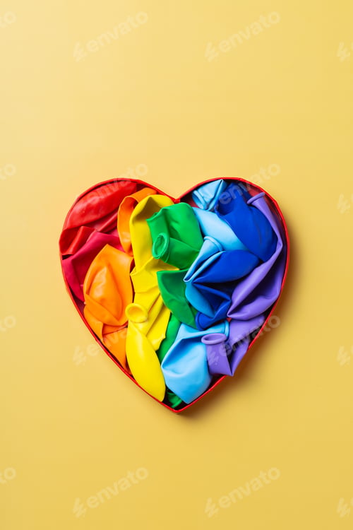 Preview: Heart shaped rainbow lgbtq flag against yellow background, pride month