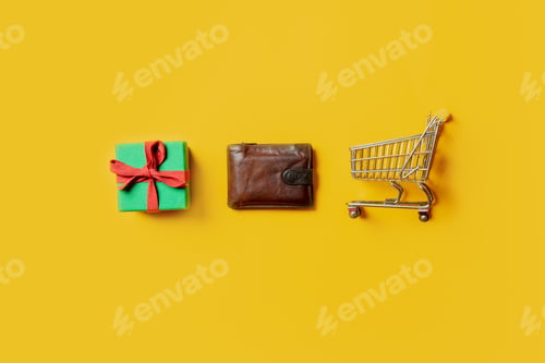 Preview: holiday gift box, wallet and supermarket cart on yellow background