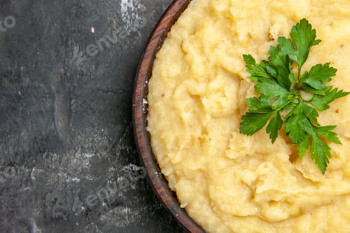 Preview: top half view mashed potatoes in wooden bowl on dark background with copy space