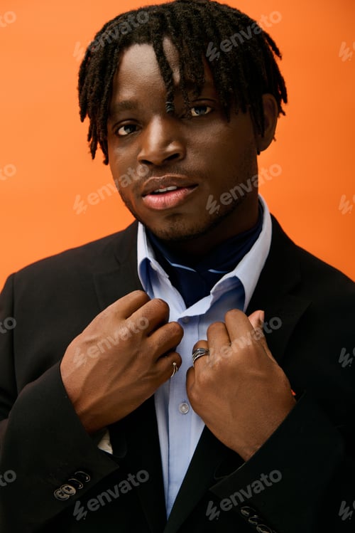 Preview: Confident young man showcasing stylish fashion in a vibrant setting