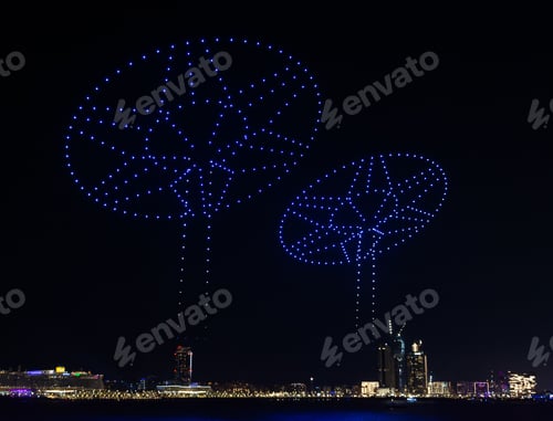 Preview: Illuminated blue drones glowing in the black night sky and forming unique shapes
