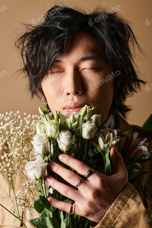 Preview: Spring fashion inspiration featuring an asian man with flowers in a stylish studio