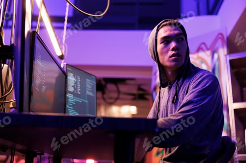 Preview: Man looking over shoulder while hacking