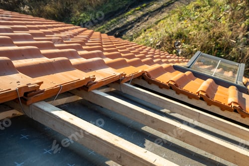 Preview: Overlapping rows of yellow ceramic roofing tiles mounted on wooden boards