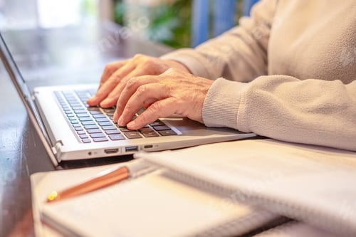Preview: Closeup on woman's hands typing on laptop while working or studying. Senior woman enjoying teaching